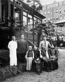 A domestic portrait outside the house at Yokohama Yamate-cho 59: Charles Soong is standing second from left. Front row from left:  Song Zian, Soong Ching-ling, Ni Gui Zhen, Song Ai-ling. Standing behind Song Ailing is a young H.H. Kung. The couple would marry in Yokohama on September 20 1914.